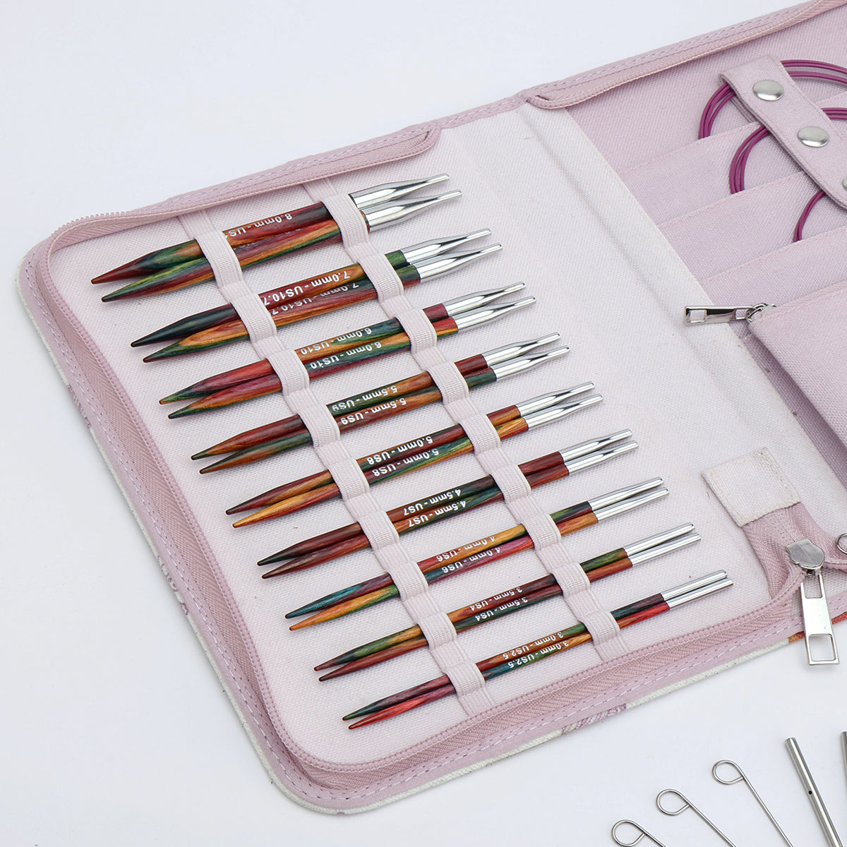 KnitPro Symfonie 2 Normal interchangeable needle set, 13 cm, Deluxe - Set of colorful knitting needles in a pink case on a white background