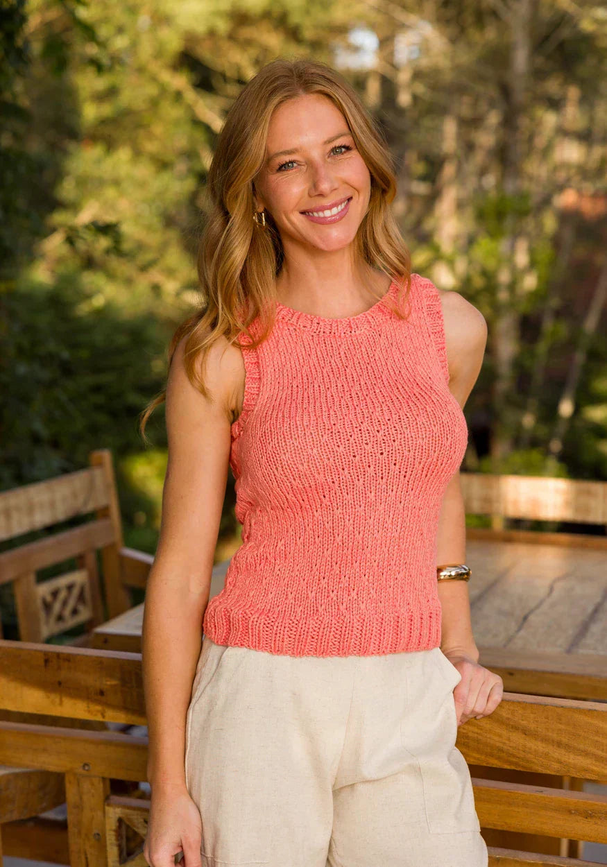 Woman wearing a coral pink top made with Circulo Aloe Vera Yarn