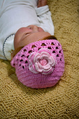 Circulo ANNE - 100% mercerized Cotton Yarn, 500m / 147g - Baby wearing a pink crochet hat with a flower on a textured yellow surface