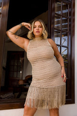 Circulo Cordone 100% Polyamide Crochet Yarn, 450 m / 100 g - Woman wearing a beige crochet dress with fringe standing in front of a glass door.