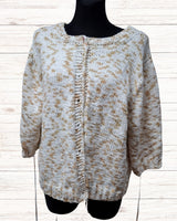 Circulo InLove  - 100% Brazilian Cotton Yarn  (125m/100g)- A chunky knit cardigan sweater with a beige and white variegated pattern, made by Mealana Austria, displayed on a black mannequin torso against a light wood plank background.