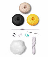 Bee amigurumi among flowers.
