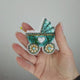 Whimsical stroller brooch kit with colorful crystals.